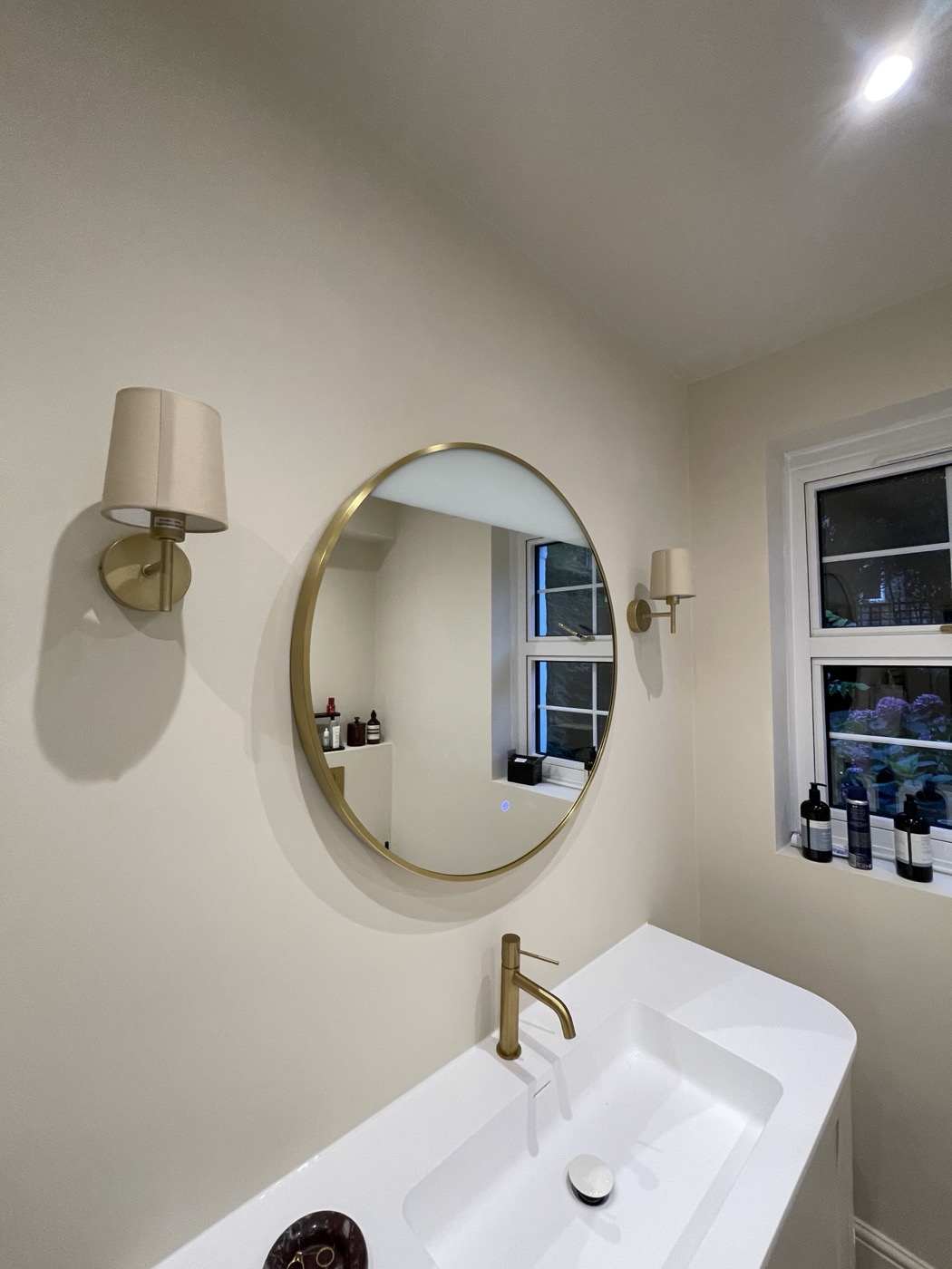 Completed bathroom renovation in Shepherd's Bush W12 with wall-hung vanity and brass mirror